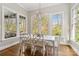 Bright dining area with wooden floors, white table set and view to exterior at 1921 Brandon Cir, Charlotte, NC 28211