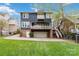 Multi-story home with private covered balcony, ground level patio, fenced yard, and garage parking at 1921 Brandon Cir, Charlotte, NC 28211