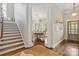 Grand foyer leading to a dining area and staircase, highlighting the home's open floor plan and elegant design at 1921 Brandon Cir, Charlotte, NC 28211