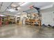 Bright garage area with storage and workspace, ideal for hobbies and projects, with tools, workbench, and refrigerator at 1921 Brandon Cir, Charlotte, NC 28211