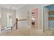Bright upstairs hallway with window seat and doorway to bonus room/office at 1921 Brandon Cir, Charlotte, NC 28211