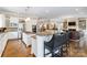 Open kitchen with island, breakfast bar, stainless appliances, and view to living room at 1921 Brandon Cir, Charlotte, NC 28211