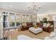 Bright living room with a large windows, leather sofa, and view of deck at 1921 Brandon Cir, Charlotte, NC 28211
