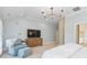 Spacious main bedroom featuring a large TV, vaulted ceiling, and cozy armchair at 1921 Brandon Cir, Charlotte, NC 28211