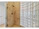 Modern shower features a glass enclosure and tile and glass-block wall at 1921 Brandon Cir, Charlotte, NC 28211