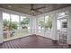 Enjoy the covered back porch with room to sit and relax with its spacious wood flooring and many windows at 2015 Dilworth E Rd, Charlotte, NC 28203