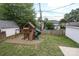 Backyard featuring a playset, open green space, and mature trees for outdoor enjoyment at 2015 Dilworth E Rd, Charlotte, NC 28203