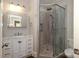 Bathroom featuring a glass shower with stone pebble floor and a white vanity with marble countertop at 2015 Dilworth E Rd, Charlotte, NC 28203