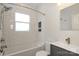 Bright bathroom featuring subway tile, a tub, gray vanity, and a large, well-lit mirror at 2015 Dilworth E Rd, Charlotte, NC 28203