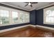 Charming bedroom with hardwood floors, large windows, and a fresh coat of paint for a welcoming atmosphere at 2015 Dilworth E Rd, Charlotte, NC 28203