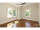 Bedroom with hardwood floors and windows which let in natural light, freshly painted, and new ceiling fan at 2015 Dilworth E Rd, Charlotte, NC 28203