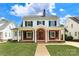 Charming two-story home with red brick and a manicured lawn showcasing its classic design at 2015 Dilworth E Rd, Charlotte, NC 28203
