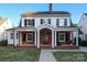 Charming two-story home with brick facade, inviting front porch with white columns and classic black shutters at 2015 Dilworth E Rd, Charlotte, NC 28203