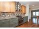 Modern kitchen with granite countertops, wood floors, and stainless steel range and vent hood at 2015 Dilworth E Rd, Charlotte, NC 28203