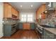 Modern kitchen featuring stainless steel appliances, tile backsplash, and wooden cabinets at 2015 Dilworth E Rd, Charlotte, NC 28203
