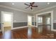 Spacious living room featuring hardwood floors, neutral walls, and a ceiling fan at 2015 Dilworth E Rd, Charlotte, NC 28203
