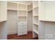A well-organized walk-in closet with built-in shelves and drawers to maximize storage space at 2015 Dilworth E Rd, Charlotte, NC 28203