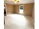 Spacious bedroom features neutral walls and carpeted floors. Window lets in natural light at 207 Morris St, Kings Mountain, NC 28086