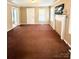 Inviting living room with warm brown carpet, white trim, and a decorative fireplace at 207 Morris St, Kings Mountain, NC 28086