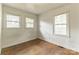 Bright bedroom featuring hardwood floors and natural light streaming through two windows at 2106 A Ave, Charlotte, NC 28216