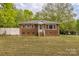 Quaint brick home featuring a well-maintained lawn and inviting entrance at 2106 A Ave, Charlotte, NC 28216