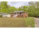 Charming brick home with a cozy front porch and ample green space at 2106 A Ave, Charlotte, NC 28216