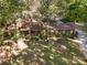 Birds-eye view of a charming home with a large yard surrounded by trees, showcasing its tranquil setting and privacy at 2415 Hargette Rd, Monroe, NC 28112