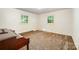 Cozy bedroom with two windows providing natural light, featuring neutral-toned carpet at 2415 Hargette Rd, Monroe, NC 28112