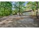Exterior view of home featuring multiple garages with plentiful parking, surrounded by lush greenery at 2415 Hargette Rd, Monroe, NC 28112