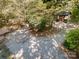 Spacious gravel driveway with a detached two car garage among mature trees at 2415 Hargette Rd, Monroe, NC 28112