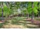 Charming single-story home featuring a spacious front yard with mature trees, creating a serene and private setting at 2415 Hargette Rd, Monroe, NC 28112