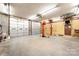 Spacious garage equipped with a lift, offering plenty of room for car maintenance and storage at 2415 Hargette Rd, Monroe, NC 28112