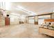 A large garage features an abundance of open space, multiple doors and windows, with workbench and storage at 2415 Hargette Rd, Monroe, NC 28112