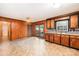 A spacious kitchen with wood cabinets, a double sink, and access to the deck through glass doors at 2415 Hargette Rd, Monroe, NC 28112