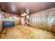 Large living room with wood paneling, carpeted floors, and natural light at 2415 Hargette Rd, Monroe, NC 28112