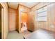 The wood paneled office offers an open doorway to a half bath and a large window at 2415 Hargette Rd, Monroe, NC 28112