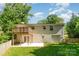 Expansive backyard includes a well-manicured lawn, patio, and a charming wood deck at 2528 Arnold Dr, Charlotte, NC 28205