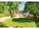 Large, fenced backyard features a well-maintained lawn and access to a spacious deck at 2528 Arnold Dr, Charlotte, NC 28205