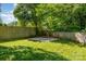 Flat backyard is surrounded by a privacy fence and mature trees at 2528 Arnold Dr, Charlotte, NC 28205