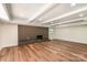 Basement with brick fireplace, recessed lighting and wood floors at 2528 Arnold Dr, Charlotte, NC 28205