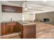 Basement wet bar with cabinets and brick fireplace at 2528 Arnold Dr, Charlotte, NC 28205