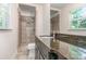 Bathroom showcasing shower with tile surround, granite countertop and vanity at 2528 Arnold Dr, Charlotte, NC 28205