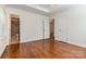Bedroom with hardwood floors, white trim, ceiling fan and doorways to other rooms at 2528 Arnold Dr, Charlotte, NC 28205