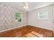 Bedroom featuring hardwood floors, neutral walls, and bright windows at 2528 Arnold Dr, Charlotte, NC 28205