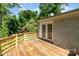 Charming wood deck with access to the home boasts beautiful views of the wooded backyard at 2528 Arnold Dr, Charlotte, NC 28205