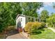 Side view of the home showing the driveway, fence, and yard at 2528 Arnold Dr, Charlotte, NC 28205
