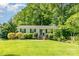Charming one-story home with a well-manicured lawn and lush landscaping at 2528 Arnold Dr, Charlotte, NC 28205
