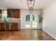 Dining area adjacent to kitchen with hardwood floors and access to outdoor deck at 2528 Arnold Dr, Charlotte, NC 28205
