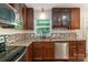 Kitchen with stainless steel appliances, granite countertops, and dark wood cabinets at 2528 Arnold Dr, Charlotte, NC 28205