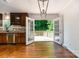 Dining area adjacent to kitchen with hardwood floors and access to outdoor deck at 2528 Arnold Dr, Charlotte, NC 28205